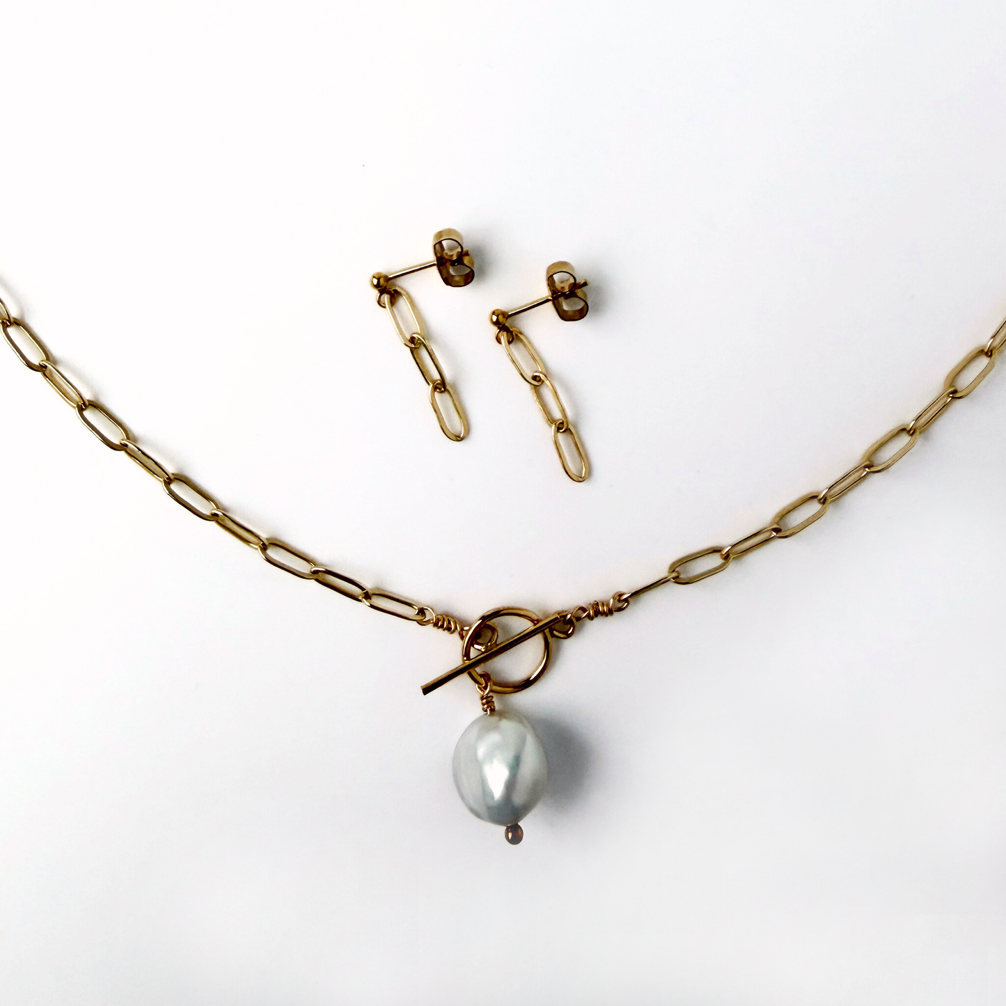 gold paperclip chain necklace with a pearl drop and matching earrings