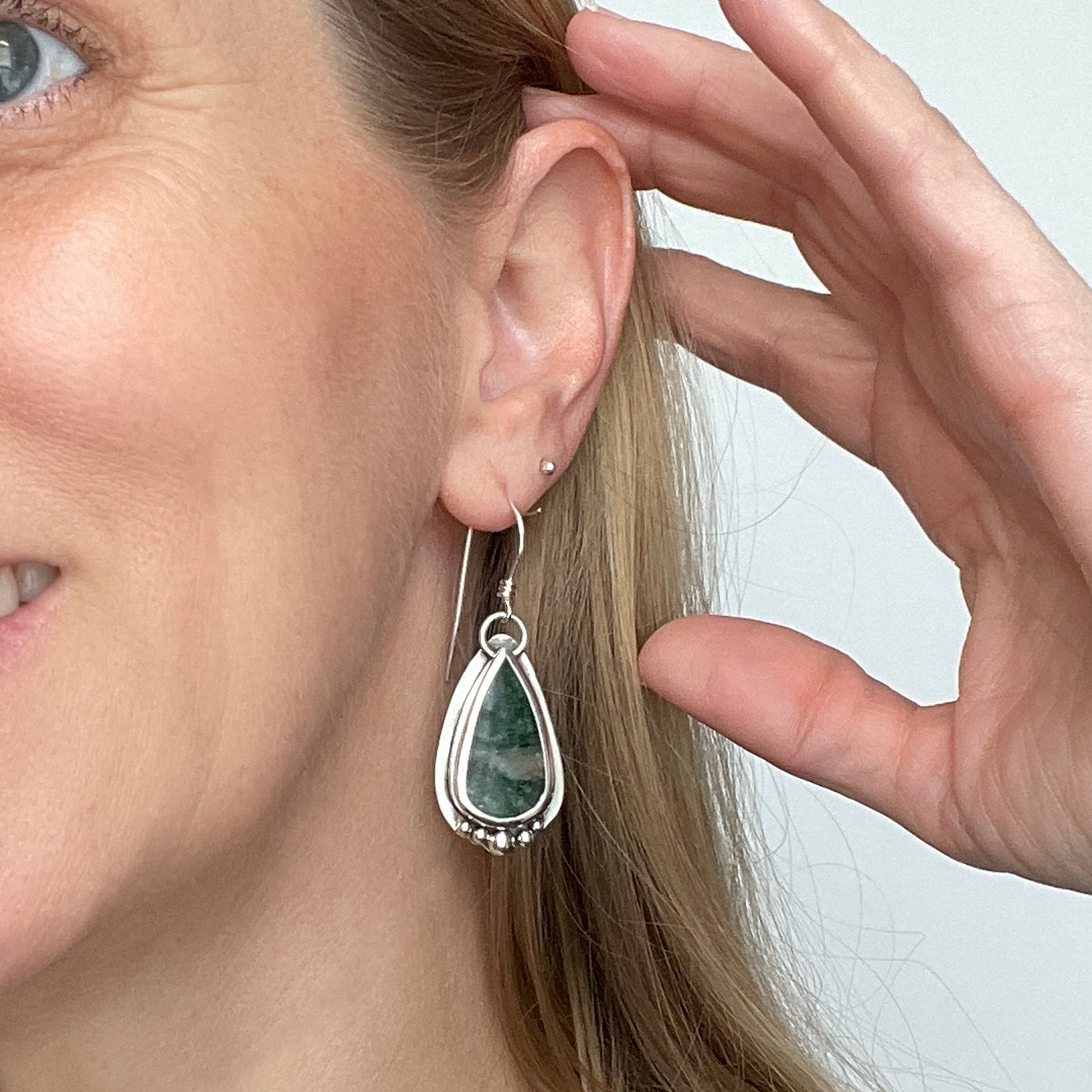 woman wearing silver and Aventurine gemstone earrings
