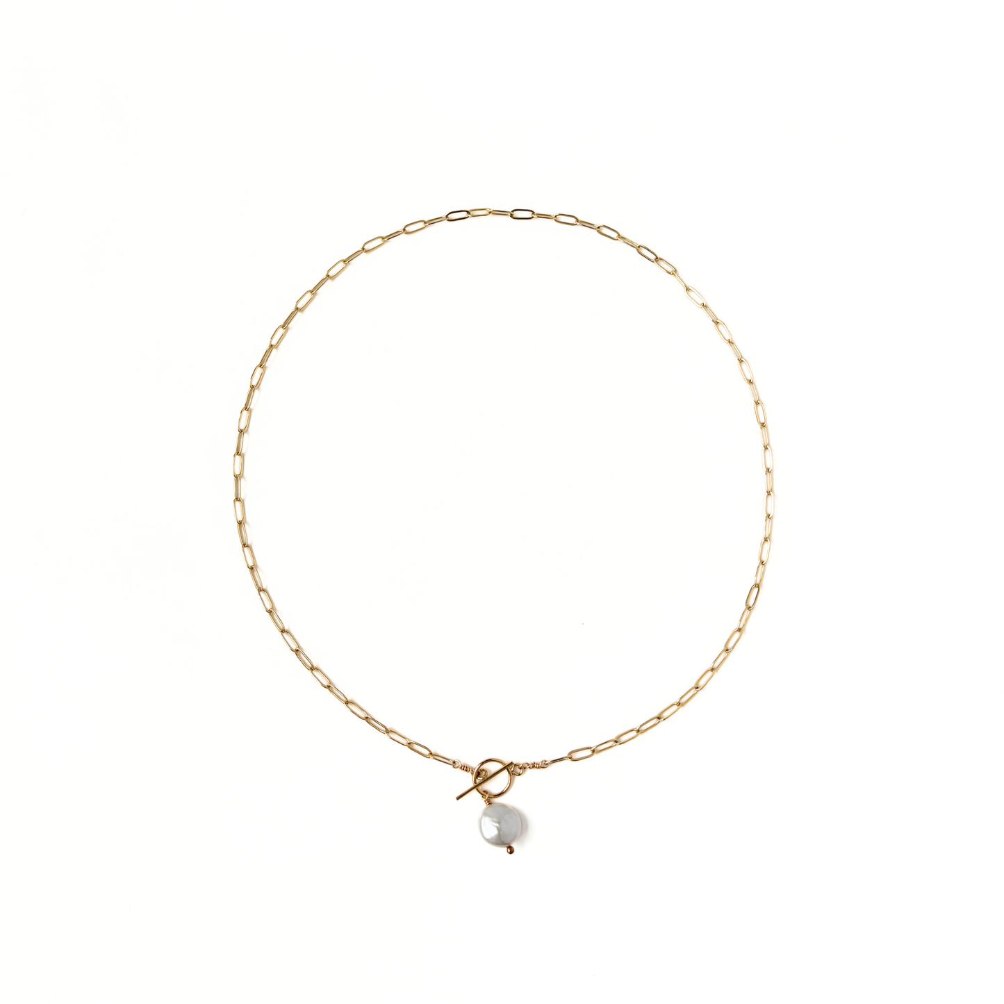 Gold paperclip necklace with a front toggle clasp and pearl drop