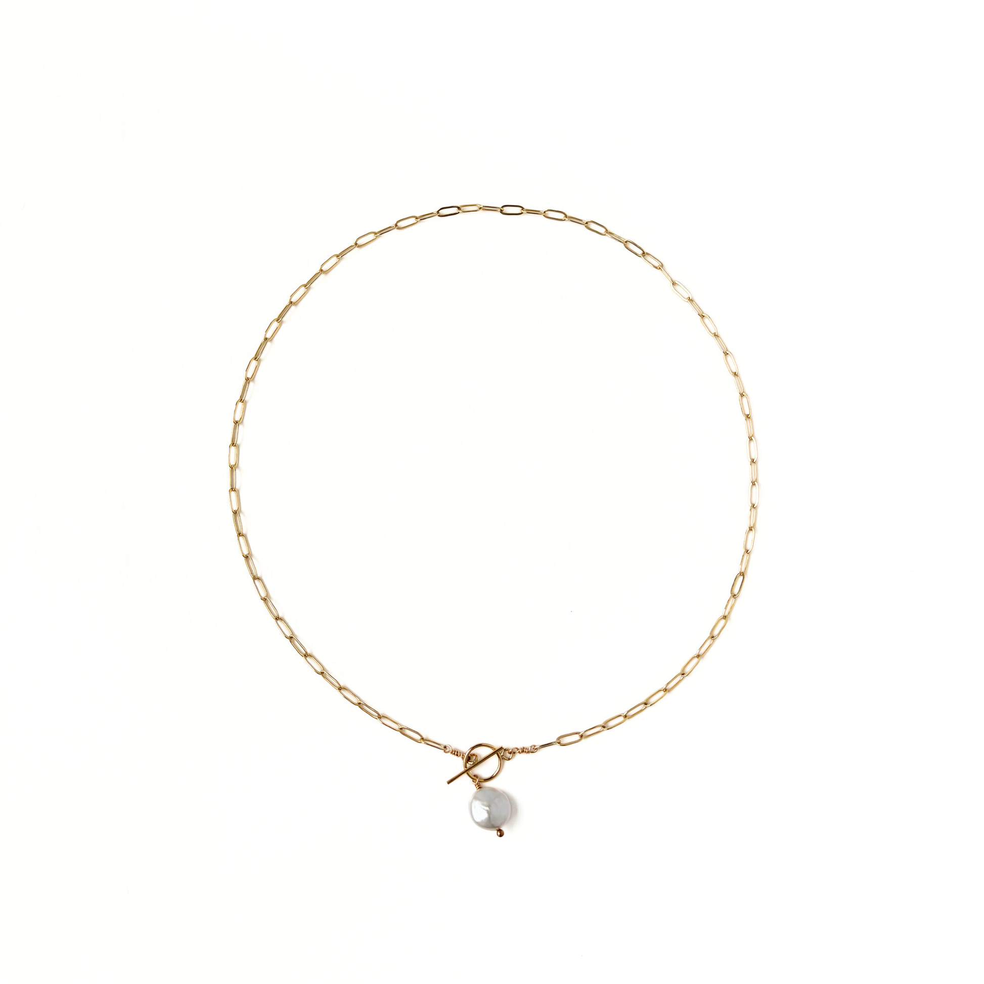 Gold paperclip necklace with a front toggle clasp and pearl drop