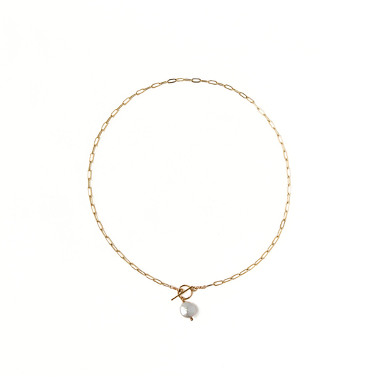 Gold paperclip necklace with a front toggle clasp and pearl drop
