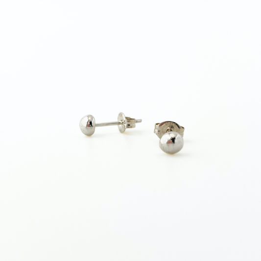Pair of silver ball stud earrings on a white background