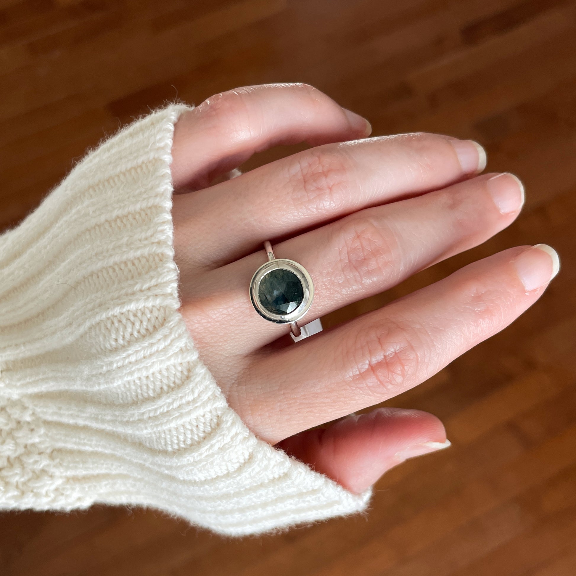 sterling silver moss agate ring worn on a hand