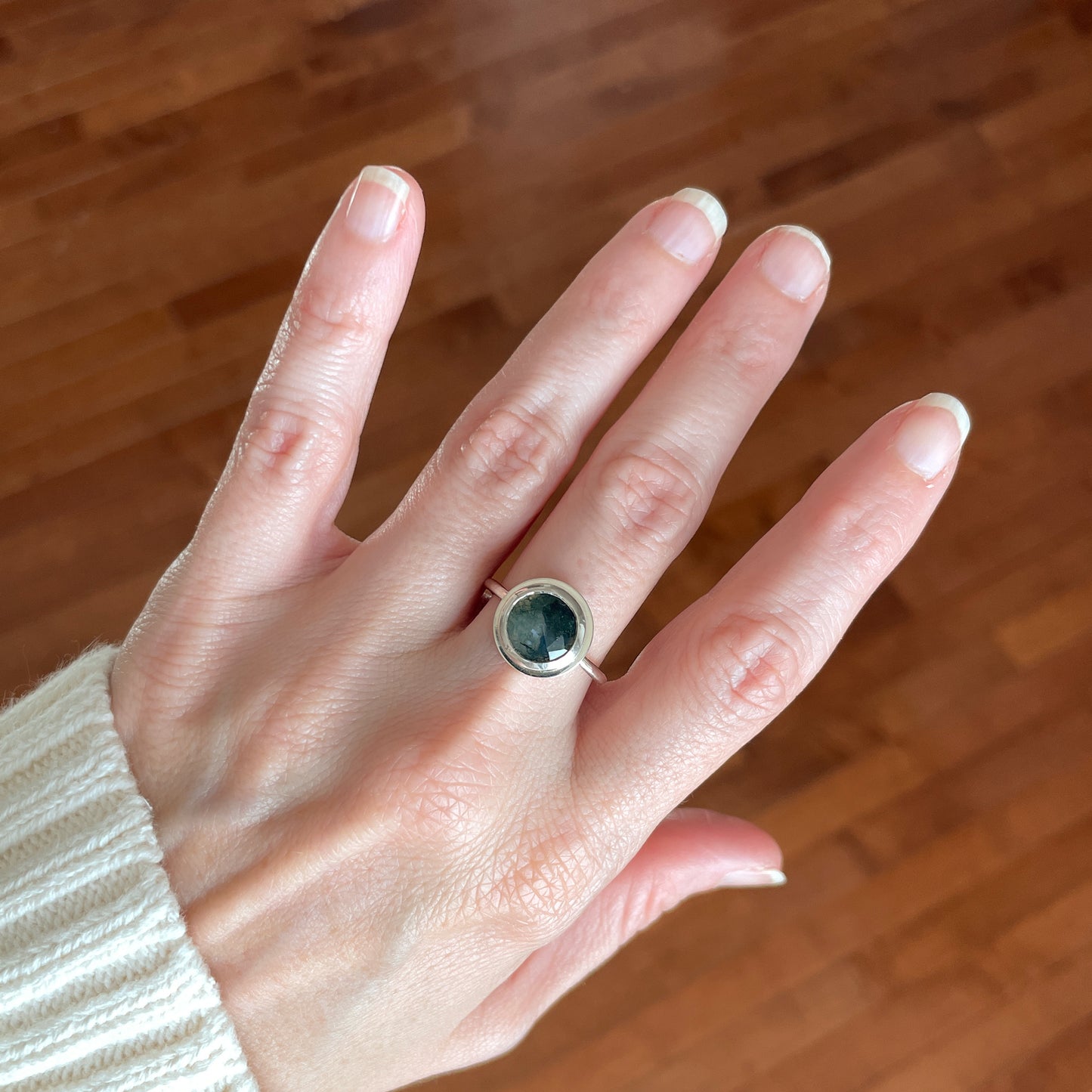 silver ring with rose cut moss agate gemstone worn on a hand