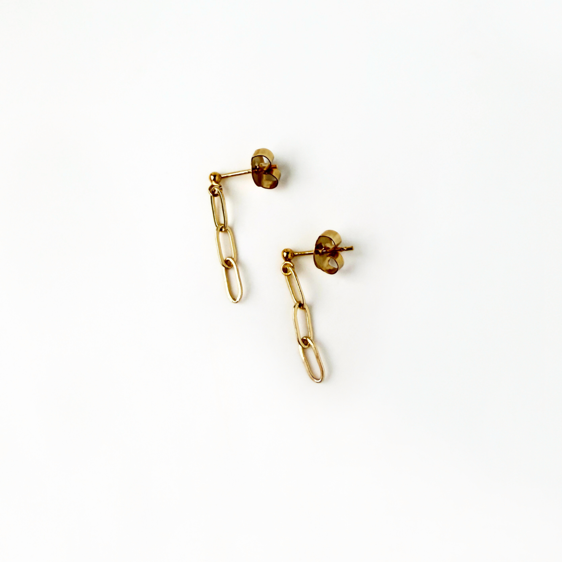 Gold chain earrings on a white background