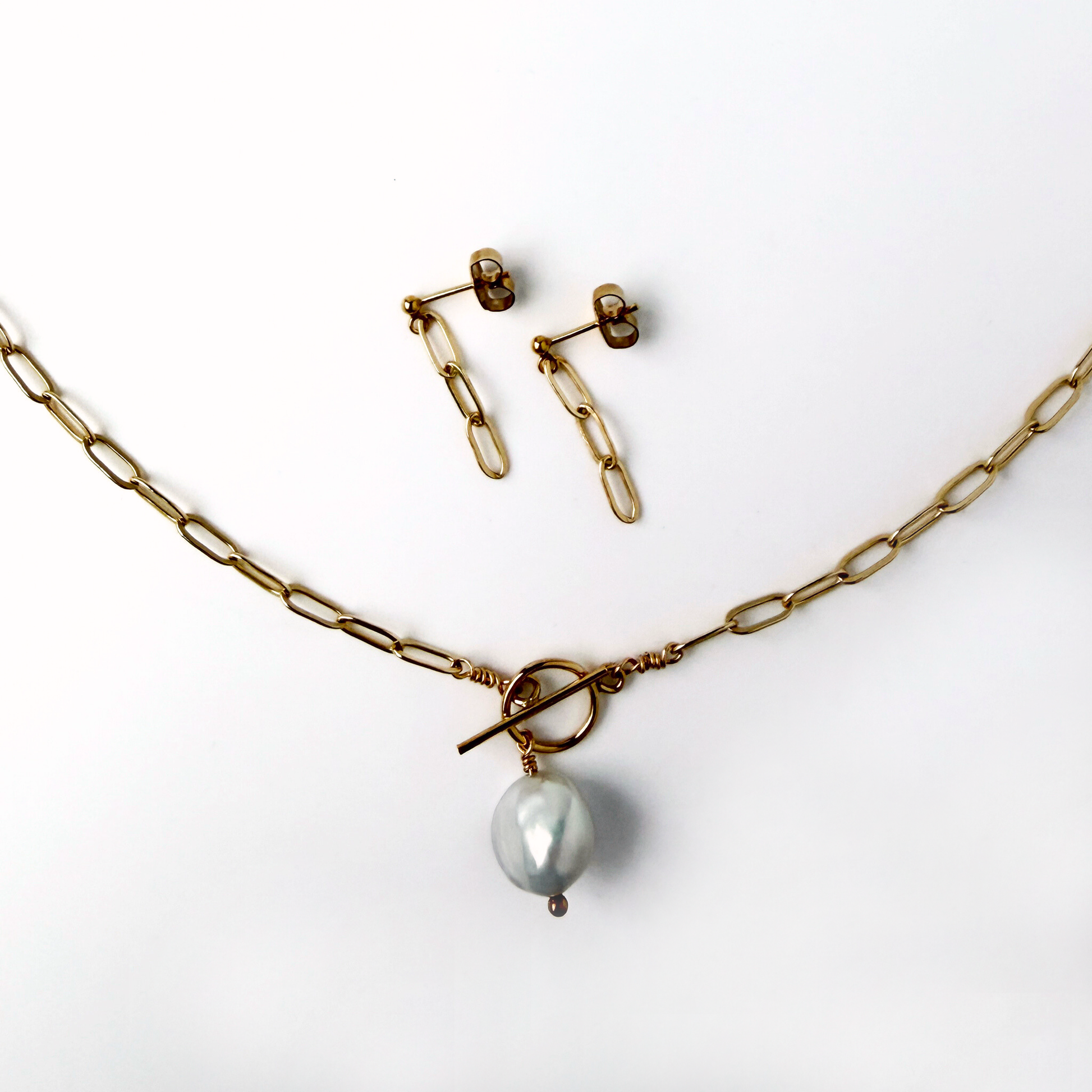 gold paperclip chain necklace with a pearl drop and matching earrings