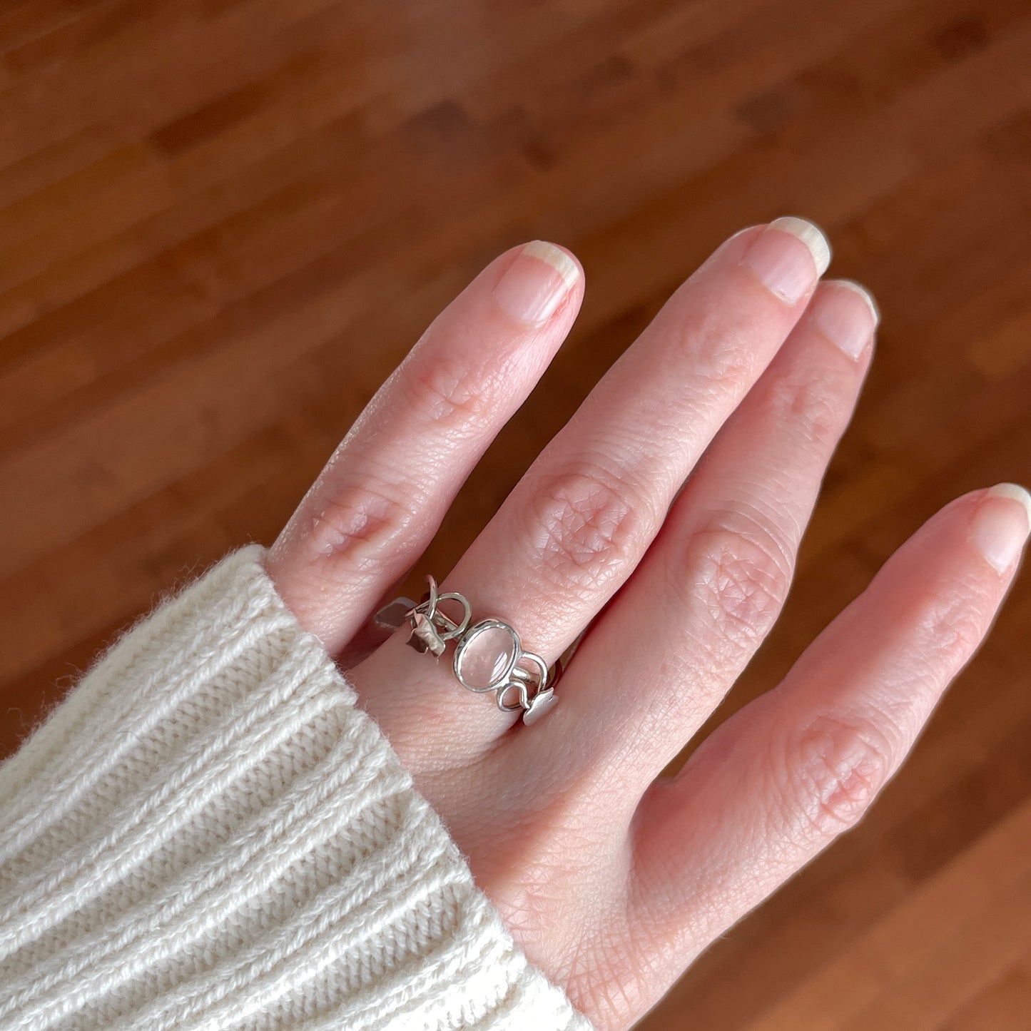 sterling silver ring with silver maple leaves and a rose quartz gemstone center