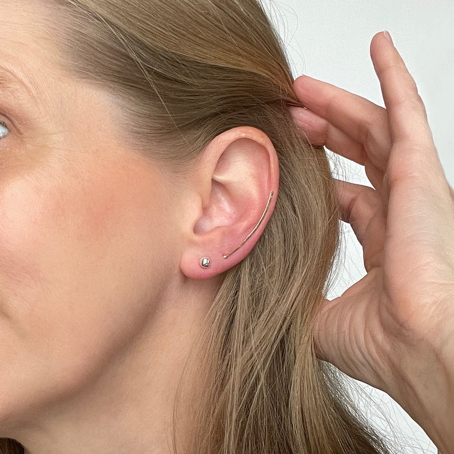 woman wearing an ear climber style earring